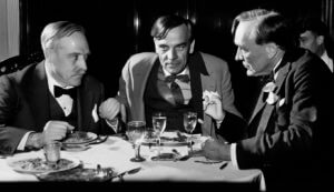 H.G. Wells, Clarence Darrow, and Charles Russel have drinks.