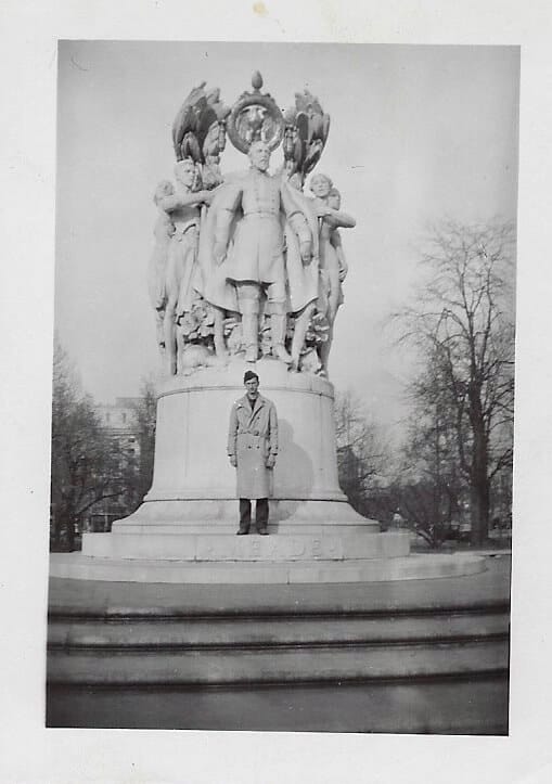 John Kessel photo of his father posing in front of a statue