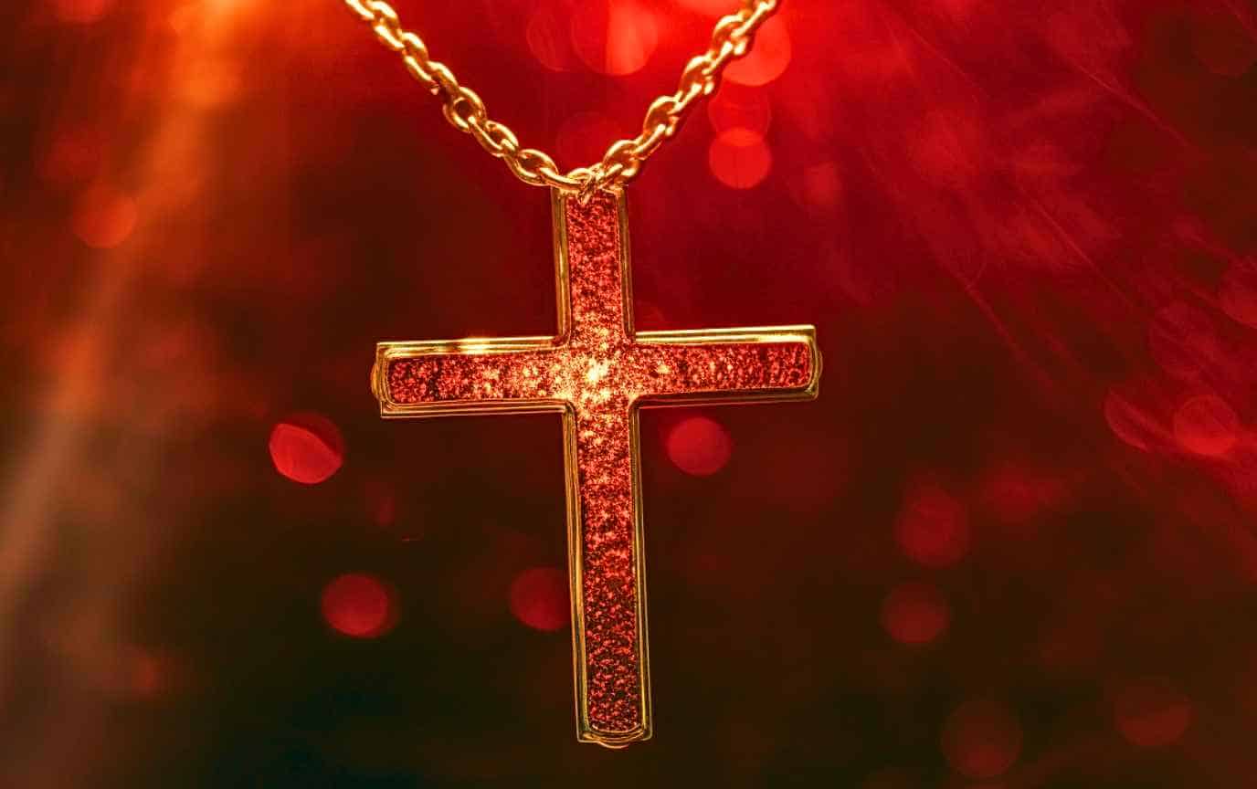 Gold cross with etching that glows red when magic is used.